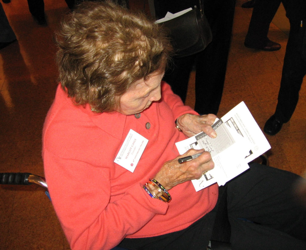 Margot Gayle signing a post card to NYC Landmarks Preservation Commission Chair Robert Tierney urging him to expand the boundaries of the SoHo-Cast Iron Historic District.